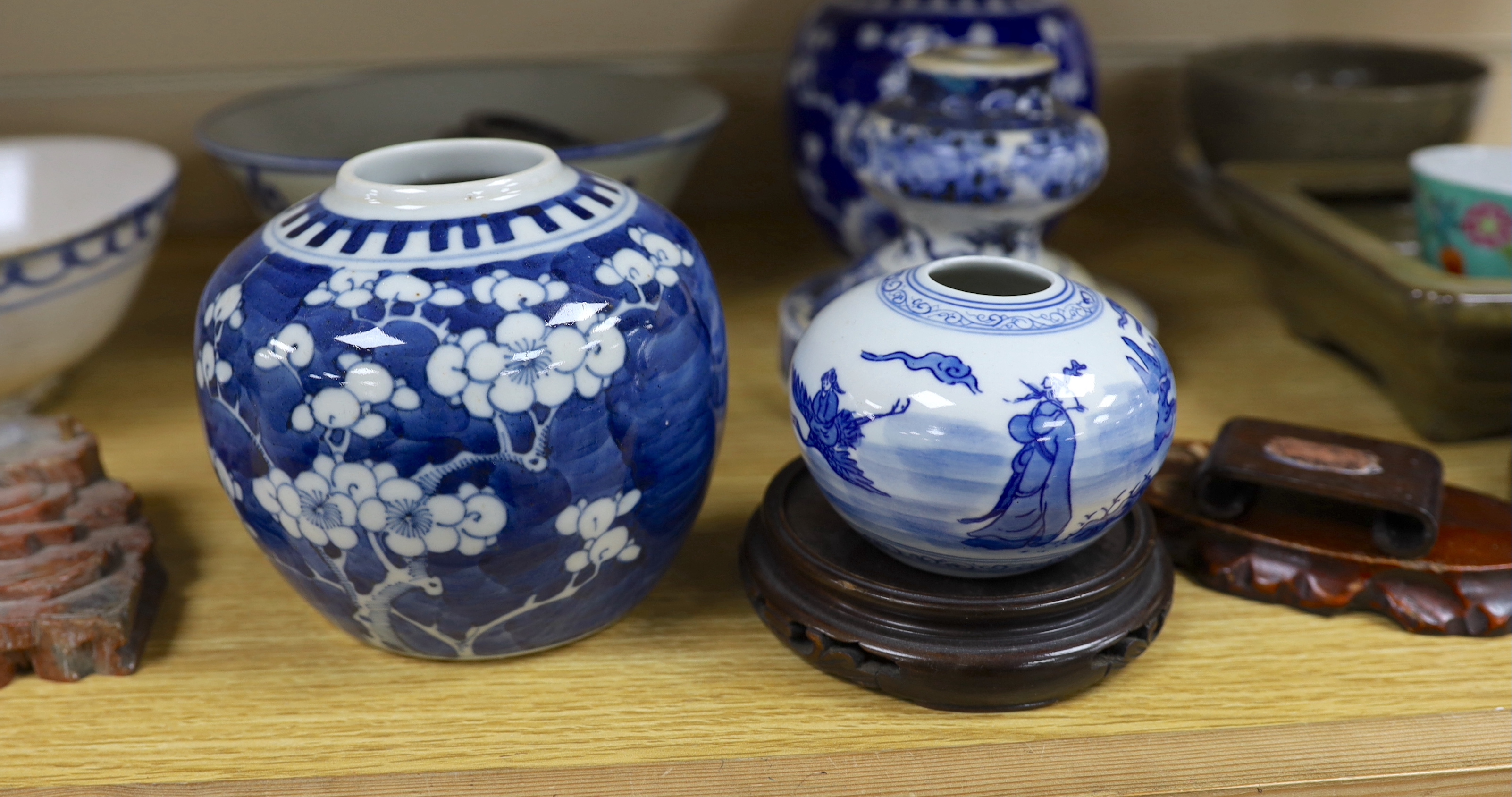A collection of Chinese hardwood stands and a soapstone example, largest 29cm wide